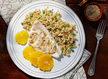 Moroccan-Spiced Fish and Couscous with Orange Slices in a Serving Dish
