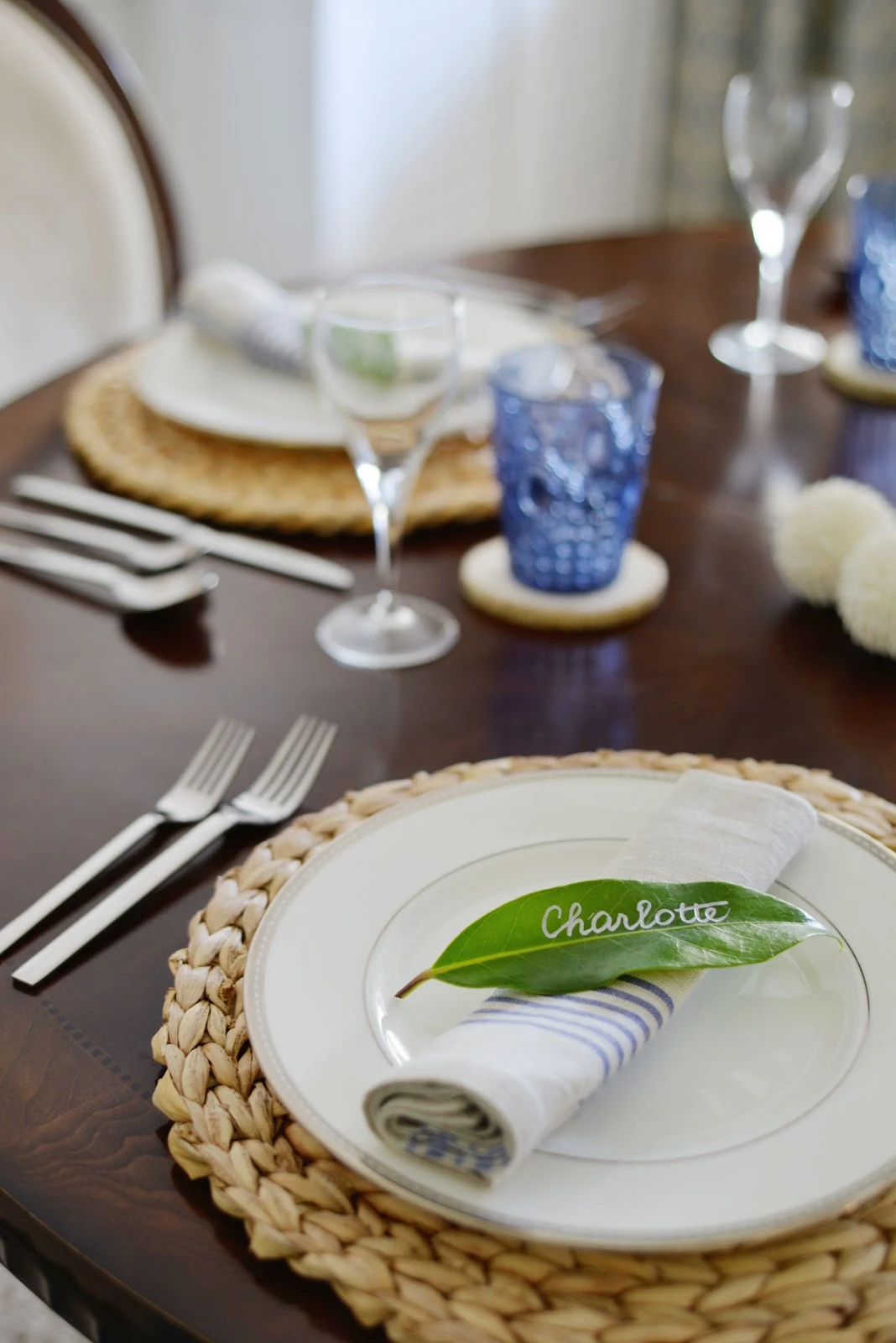 Rambling Renovators | tropical dining room with rattan charger, leaf placecard