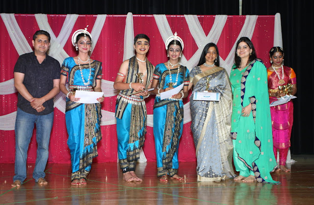 Following several cultural performances to mark the occasion of the 25th anniversary of the Hindu Temple &amp; Community Center in Sunnyvale, Calif., Temple board member Sanjay Birla (left) awards certificates to some of the artists, along with his wife Shweta Birla (2nd from right). (Som Sharma photos)