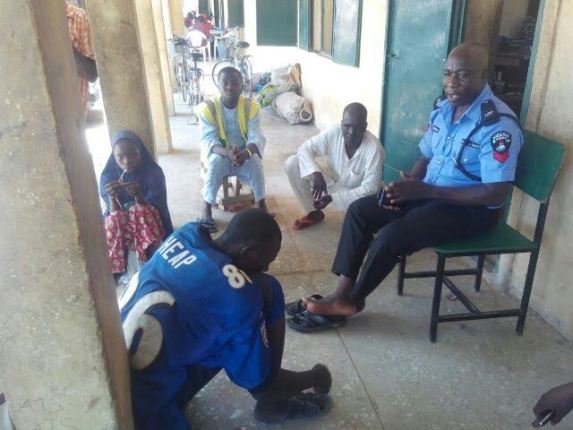 3 Officials at IDP camp in Maiduguri pictured settling a dispute between husband and wife
