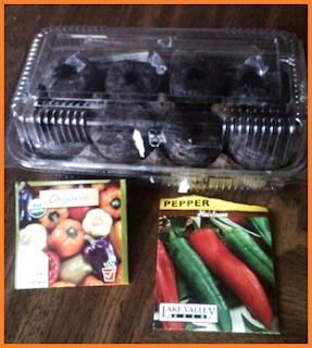 Rectangular clear plastic container holding 8 pellets within portions egg carton.  Seed packages on bottom: Organic purple, yellow, white, red, and orange bell peppers, and heirloom Anaheim chile peppers.