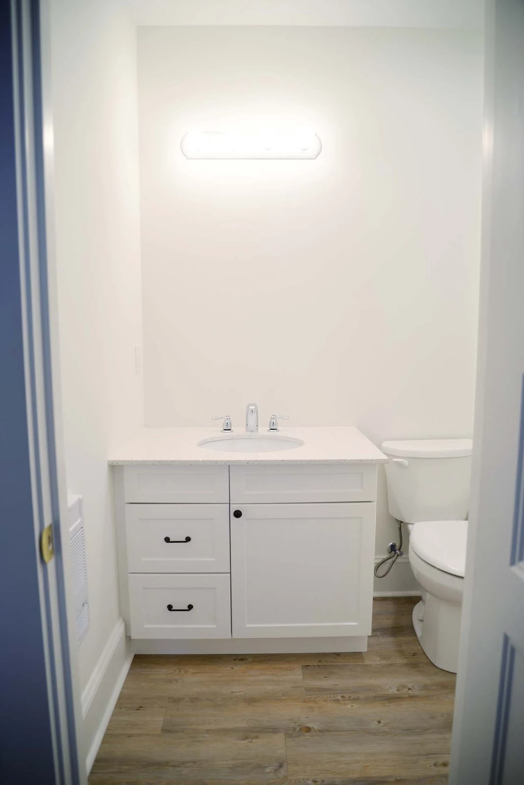 white cottage beachy bathroom | beadboard cabinet