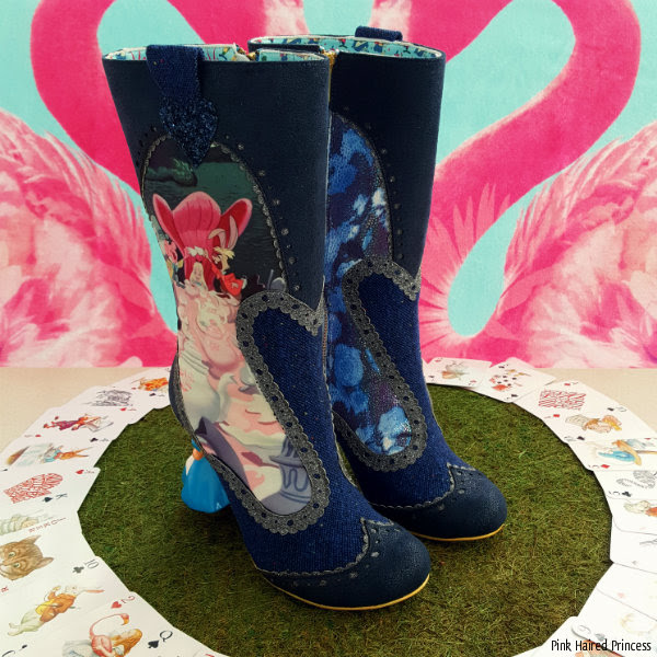 Irregular Choice Alice Lost Your Muchness boots standing Irregular Choice Alice Lost Your Muchness boots standing on grass with flamingo background and circle of playing cards