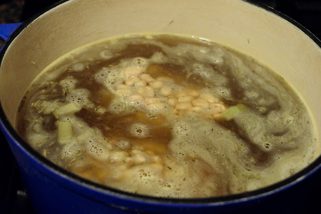 The white beans being added to the pot. 