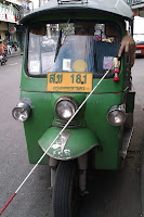 Mike driving a Tuc Tuc with help from his cane