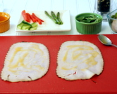 Spread honey mustard on deli turkey.