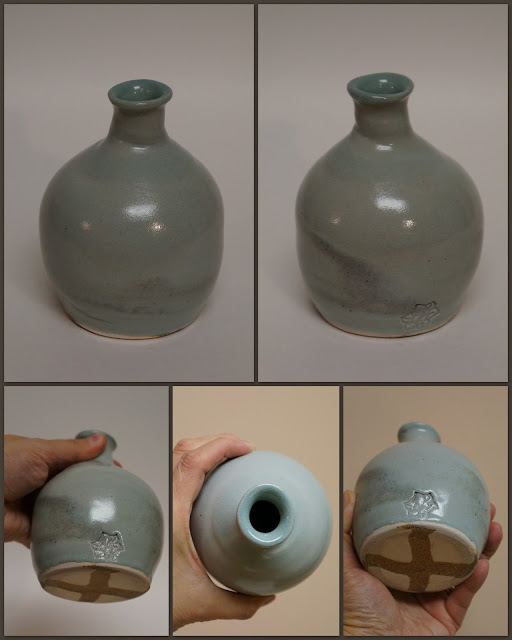 Ceramic pottery narrow necked vase / vessel with marbled design.