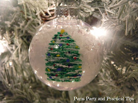 Painted Christmas tree ornament hanging in a tree