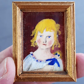 One-twelfth scale framed painting of a girl holding a doll