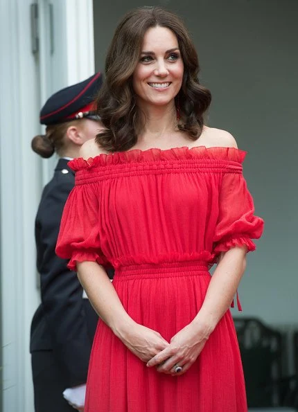 Kate Middleton's dress is by Alexander McQueen Off-the-shoulder shirred cotton and silk-blend. Simone Rocha Crystal earrings, Prada Pumps, Club Monaco Channon Heeled Sandal