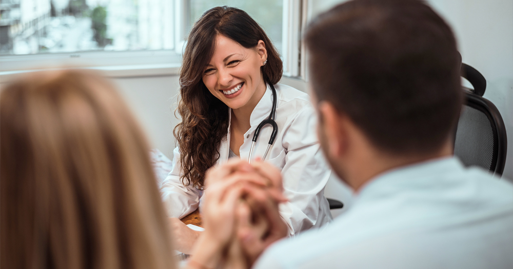 couple at prenatal appointment with doctor