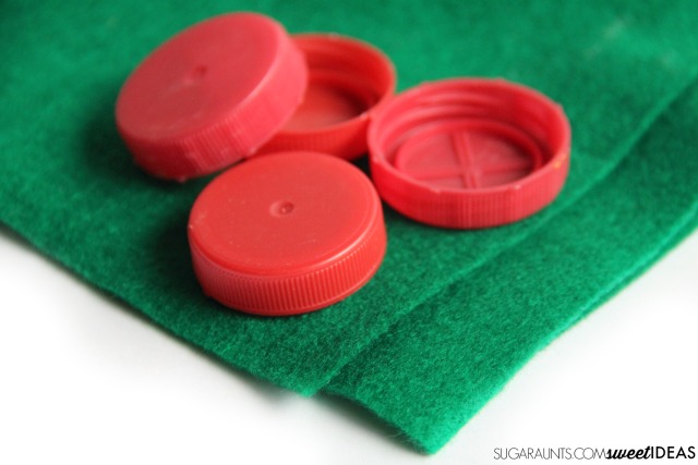 Make this bottle caps holly craft using recycled bottle caps for a fun Christmas tree holly ornament, a gift topper, or a holiday wreath.