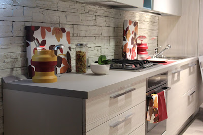 Szafki kuchenne w jasnym kolorze z obrazami i dekoracjami na blacie