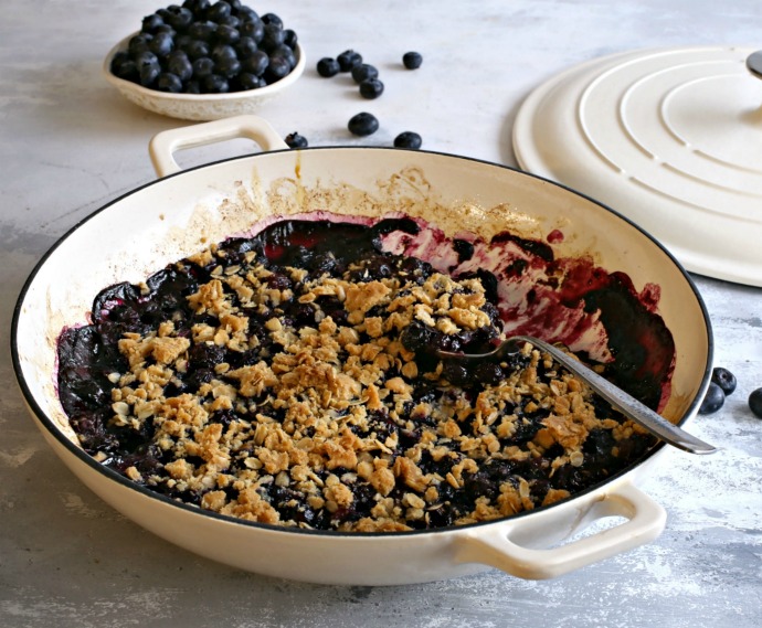Crumble topped blueberry dessert cooked in a Dutch oven.