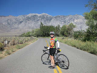 pep with bicycle alone Pine Creek, mountains in the distance, near Bishop, California