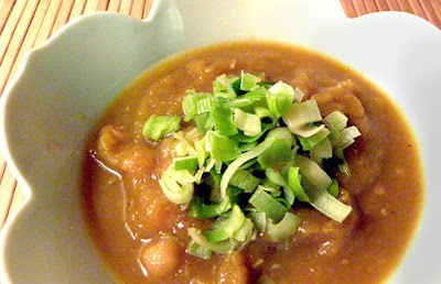 Bowl of Moroccan pumpkin soup topped with leeks