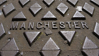 Manchester, public domain via pixelbay Cast iron cover with the name "Manchester"