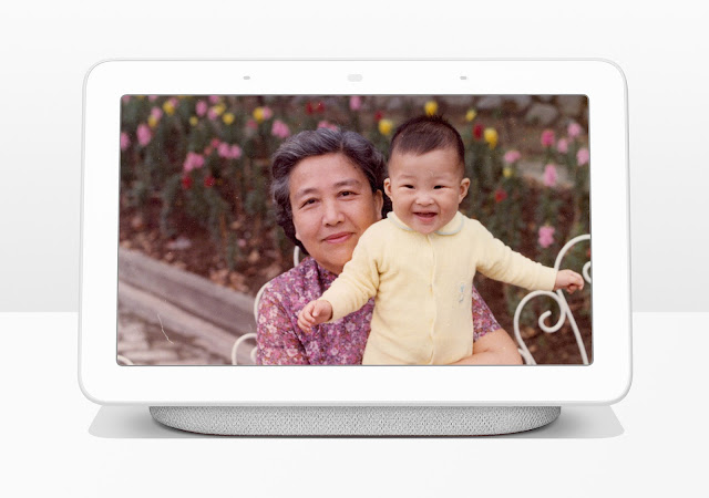 Photo of Home Hub device, displaying a family photo with a grandmother and a child
