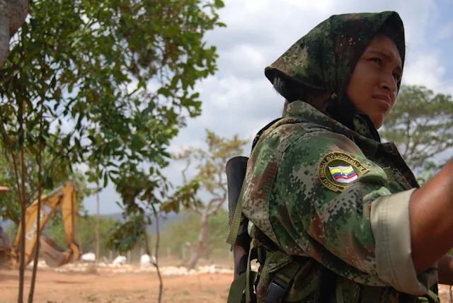 FARC guerrilla, Solange Mendoza, on guard duty at the FARC's Tierra Grata demobilization zone in northern Colombia, in the province of Cesar, near the town of San Jose de Oriente. February 15, 2017. Photo: Anastasia Moloney