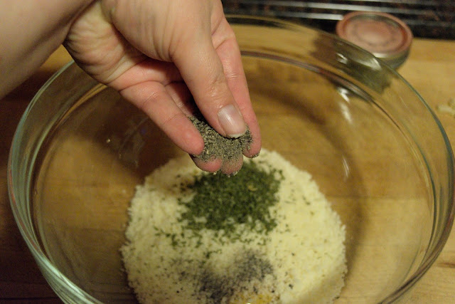 Pepper being added to the mixing bowl with the grated cheese, egg yolks, and parsley.  
