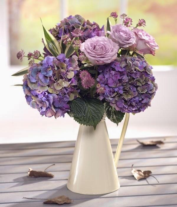  Zinc Jug with Blue Hydrangea and Lilac Roses.