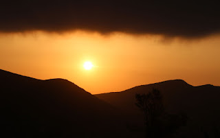 The sun rises between the mountains and the clouds The sun rises between the mountains and the clouds