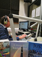 Richard - producer. Community Focus. Image of Richard at the computer wearing headphones. Community Focus, CalonFM