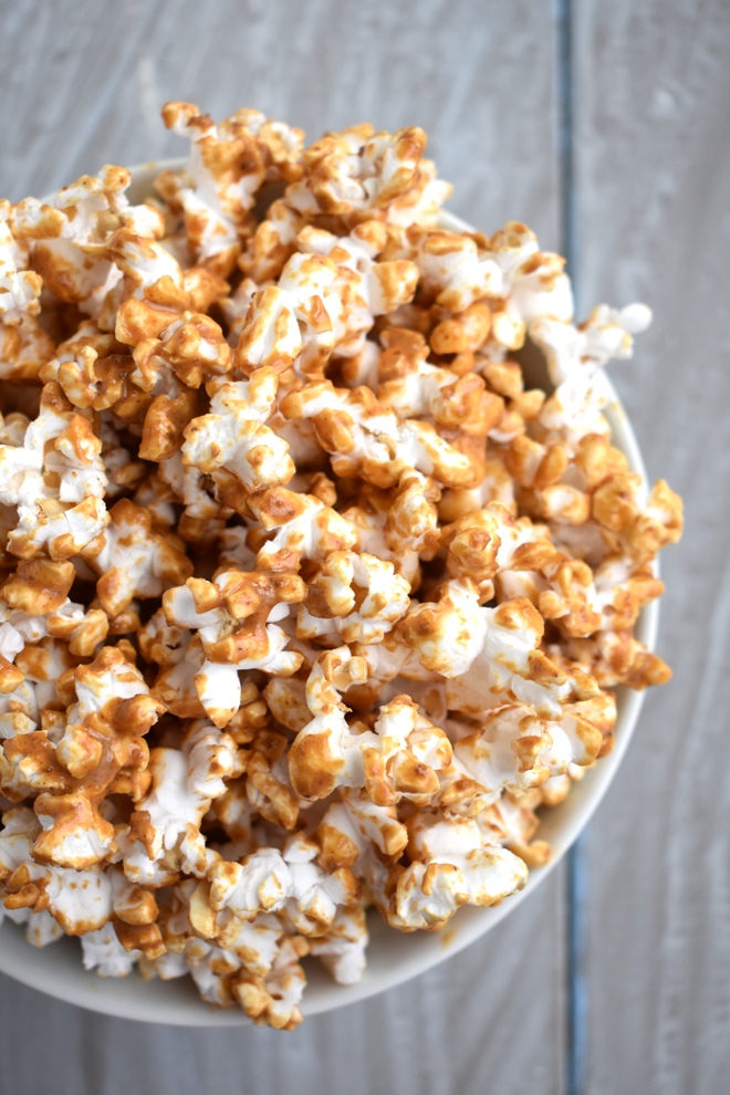 5 healthier popcorn mix-ins for a fun and delicious snack: peanut butter popcorn, garlic bread popcorn, apple cinnamon popcorn, s'mores popcorn and smoky BBQ popcorn. www.nutritionistreviews.com