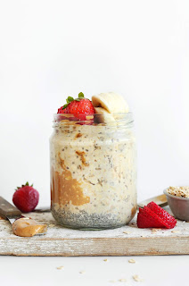 jar of overnight oats with strawberries and banana sliced on top