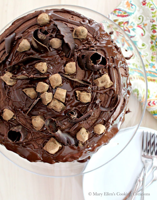 This cake is a chocolate lover's dream - a rich, double-layer chocolate cake with a creamy, whipped ganache. The cake is dressed with hazelnuts that have been toasted, candied, coated in tempered chocolate and rolled in Dutch cocoa powder, and with fancy bittersweet chocolate swirls. Chocolate Hazelnut Cake