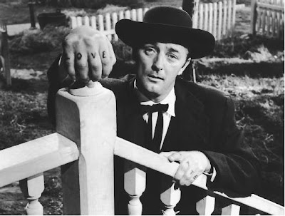 Robert Hitchum as the evil preacher Harry Powell in The Night of the Hunter