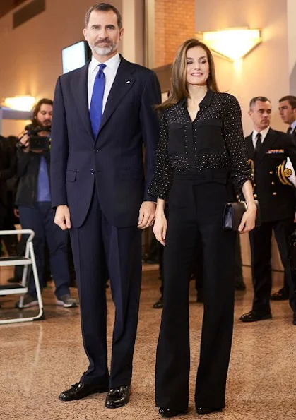 Queen Letizia wore Uterque Blouse, carried Nina Ricci Arc Clutch, Magrit Shoes, Tous Jewelers Earrings, wore Boss Trousers