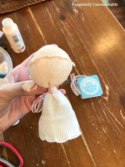 Painting The Head Of A Sock Doll