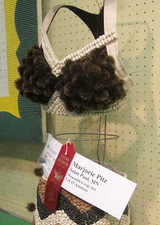 Bra made with white beans on the straps and black coneflower cones on the cups