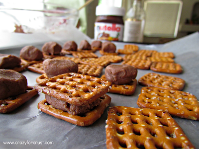 Pretzel squares topped with nutella.