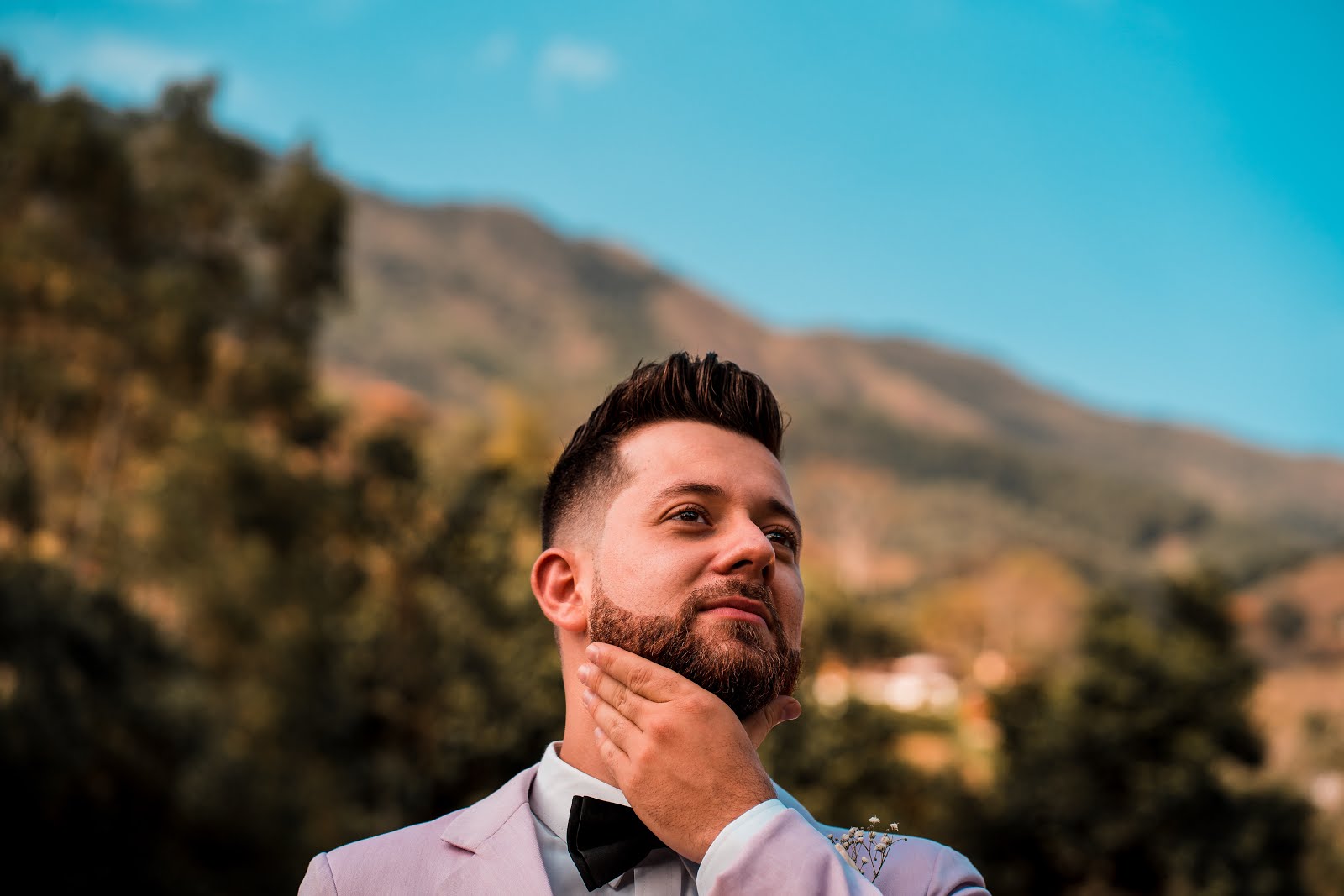 How to Grow a Beard - Growing a Beard Tips man holding his beard