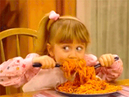 Little girl eating noodles