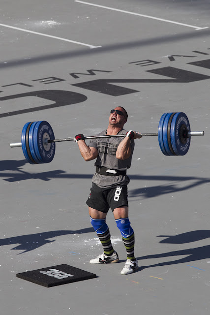 Image of 2012 CrossFit Games competitor struggling to lift a barbell loaded with weight