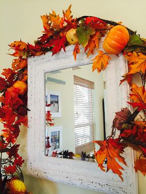 Fall garland over mirror, Fall decorated hutch, Ikea shelving, black and white dishes, Orange Halloween dishes