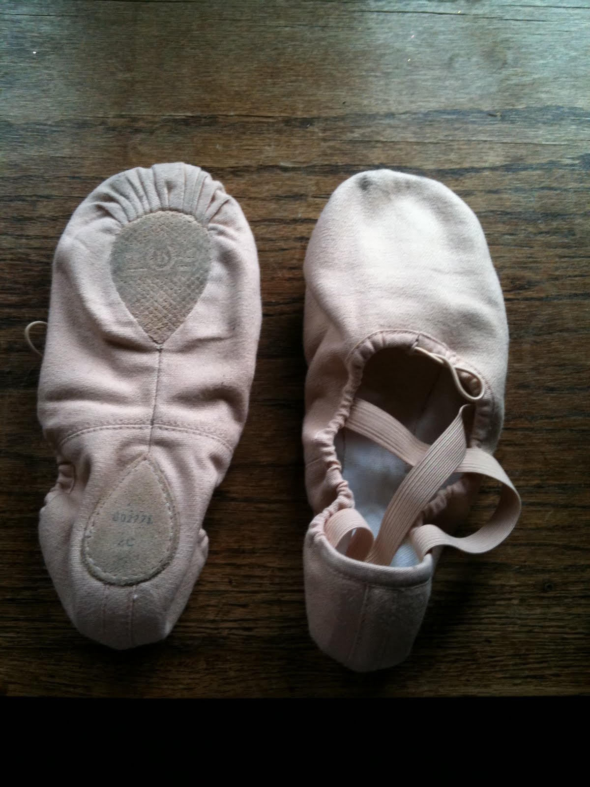 A pair of ballet slippers arranged meticulously on a reflective surface, symbolizing the precision and intentionality required to navigate modern autonomous systems—where every choice, like every step in ballet, benefits from both artistry and discipline.