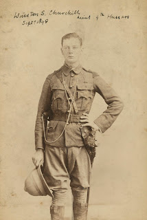 A photograph of a young man in uniform, labeled "Winston S. Churchill" by hand.