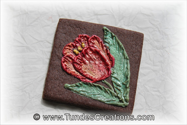 Chocolate square cookies with painted flowers by Tunde Dugantsi