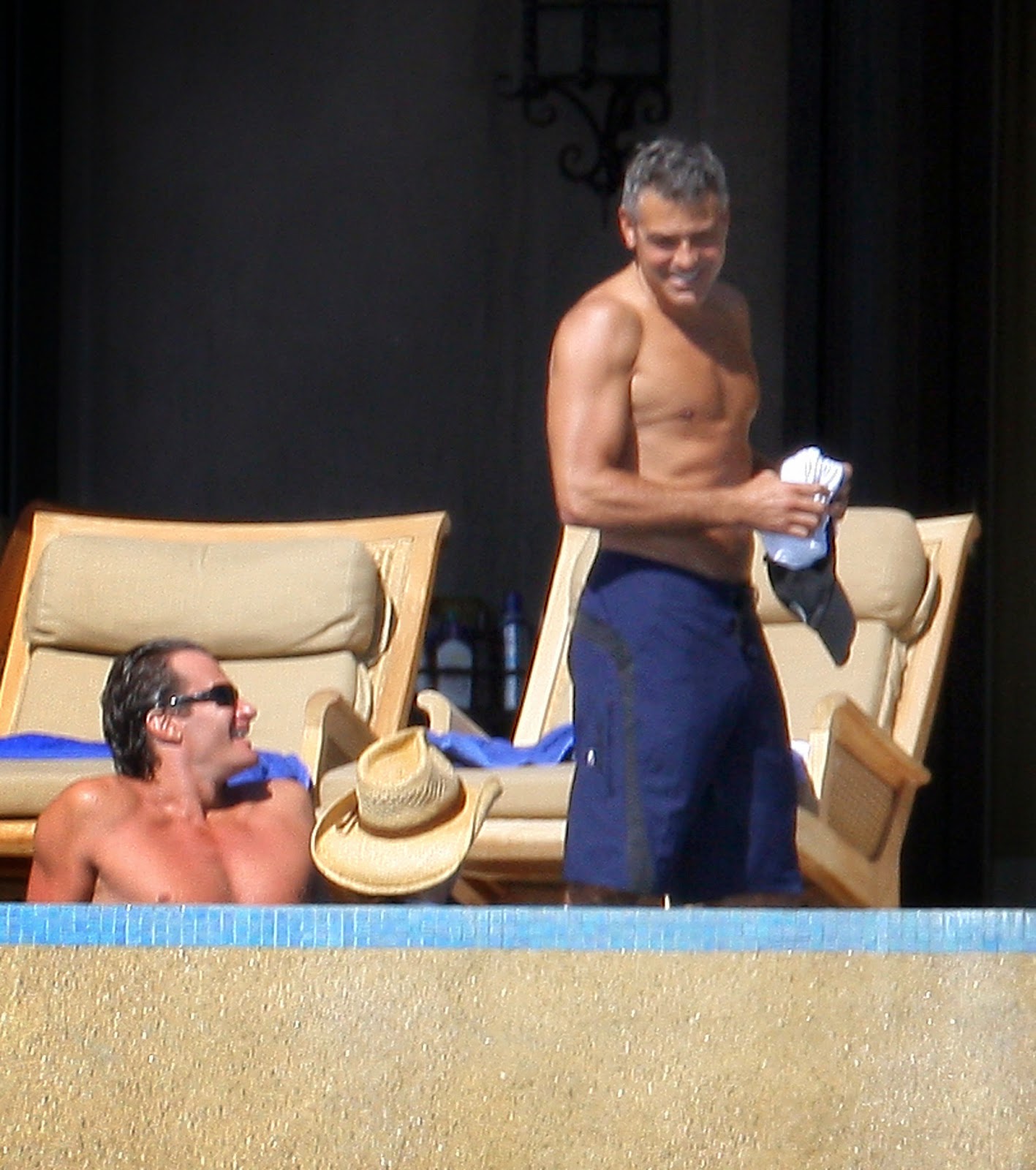 George Clooney shadows dance across his naked body