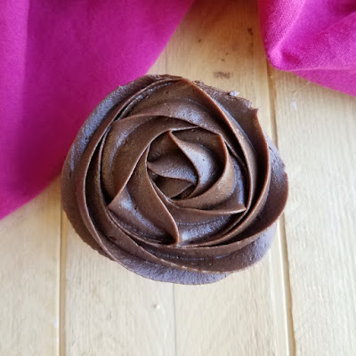 Silky smooth and super chocolaty, this fudge frosting is perfect for piping out designs on cakes and cupcakes. Of course is spreads like a dream too, make a batch and see for yourself! looking down on chocolate frosting rosette