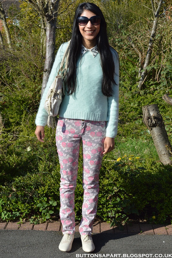 a picture of an outfit with  floral print jeans and mint green jumper 