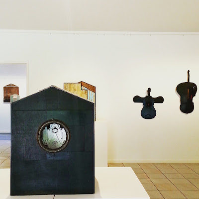 View of an art gallery exhibition of Alex Asch assemblage art pieces.