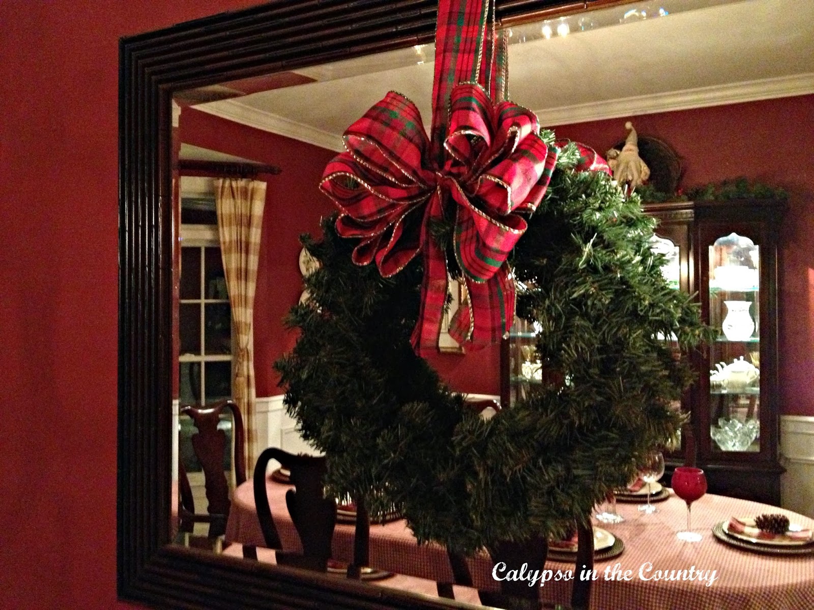 Wreath hung on mirror in dining room
