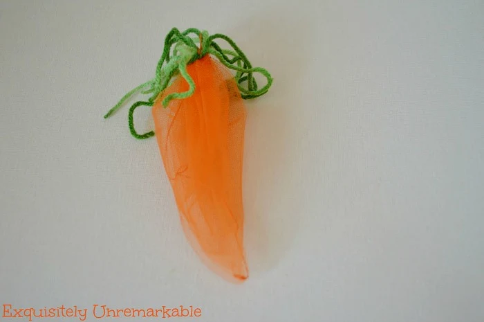 A carrot made from tulle and yarn