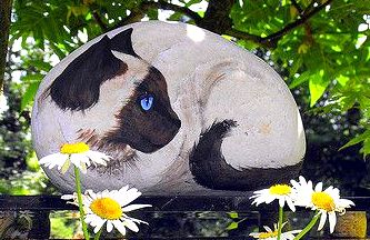 Painted cat on a rock...