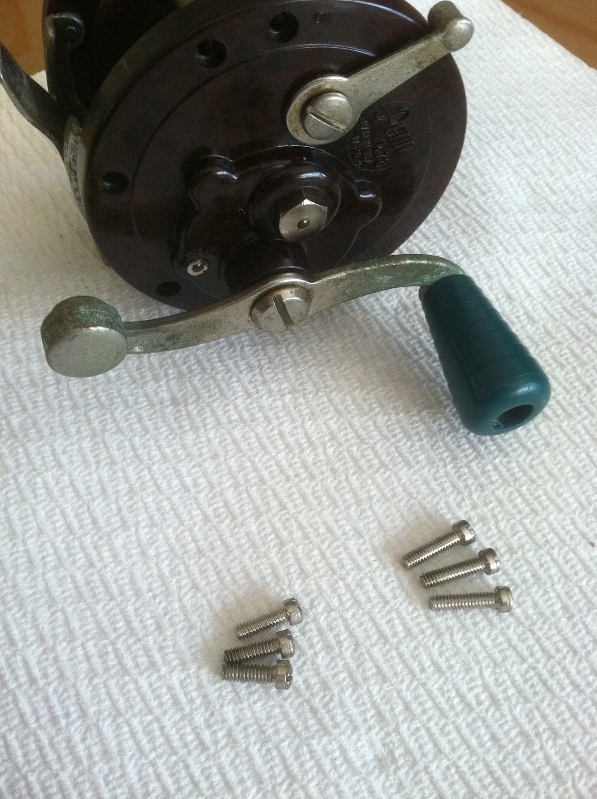 Once screws have been removed, detach right side plate from spool. This